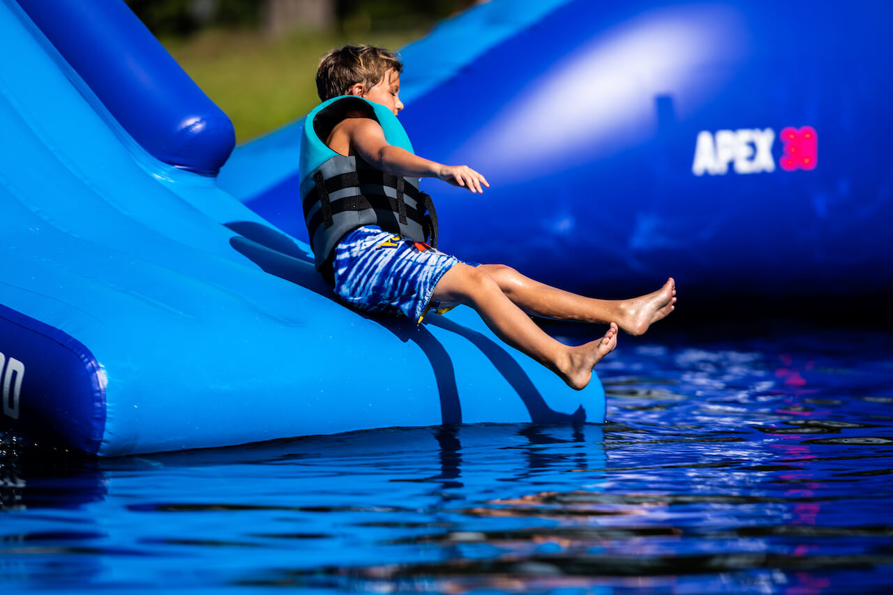 Kid slides down into the lake