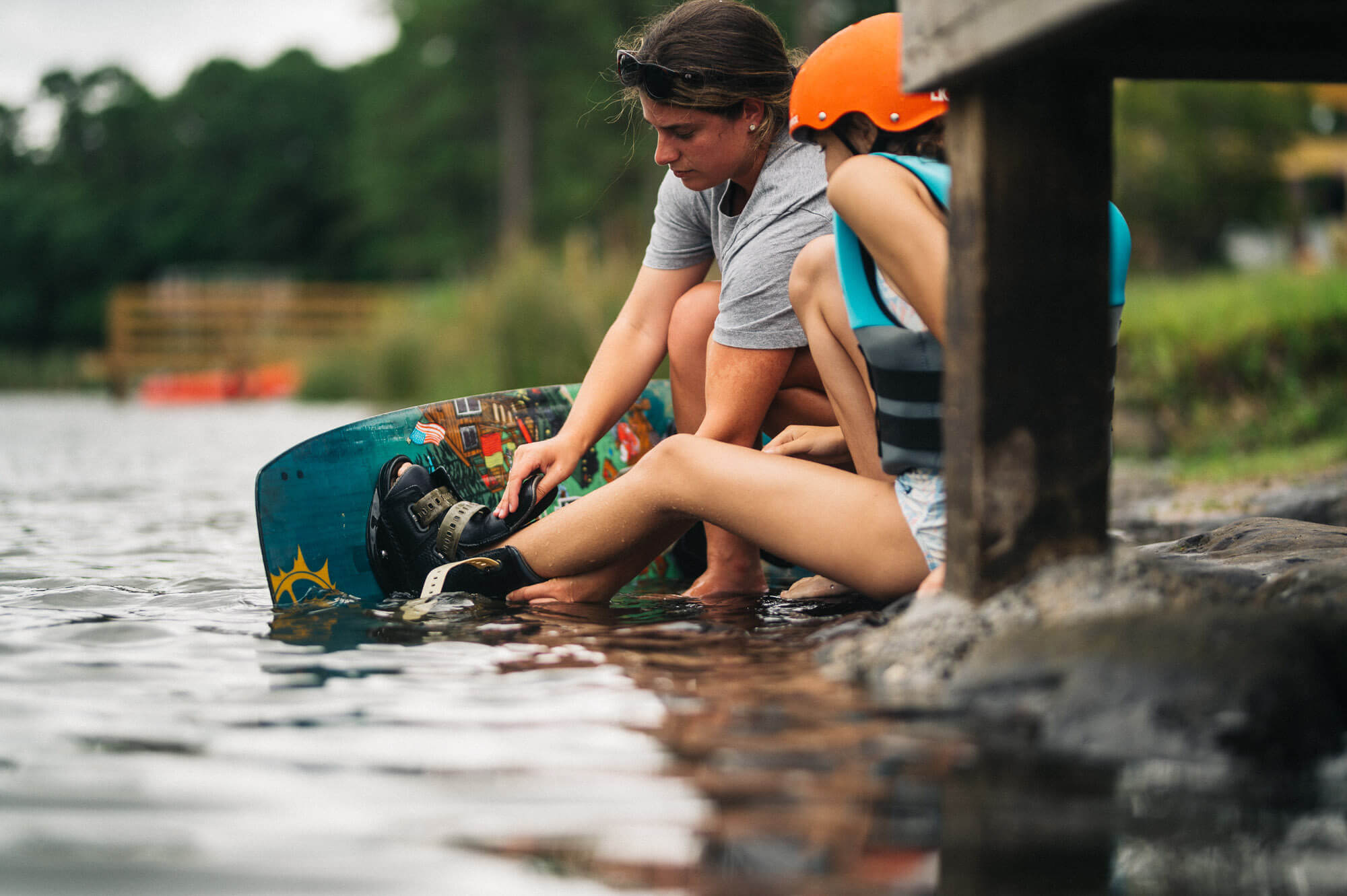 Child got instructed for a cable park session from staff member