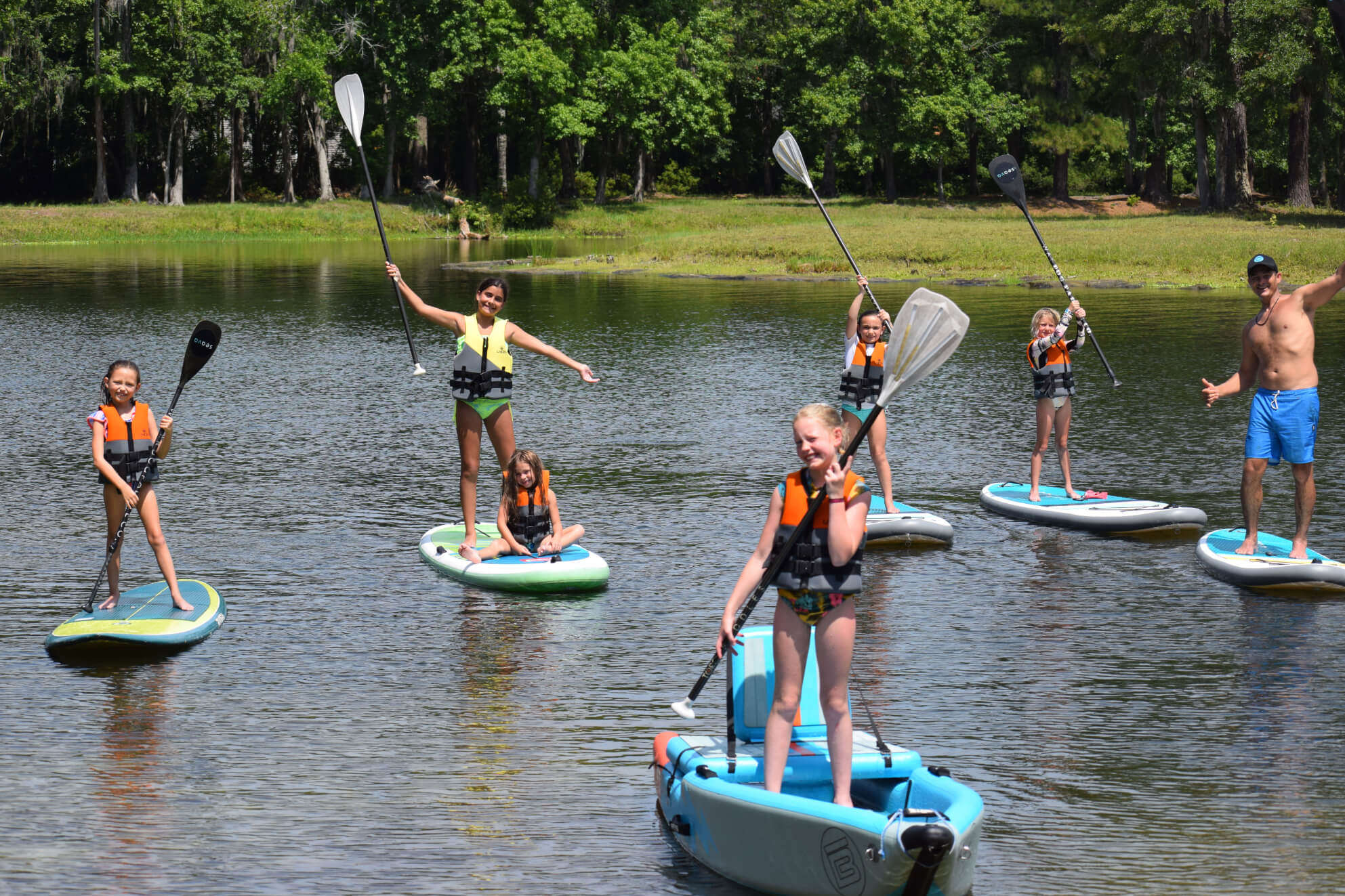 Kids standing on their paddle boards